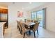 Bright dining room with a large wooden table, seating for ten, and sliding glass doors to the patio at 299 Marcello Blvd, Kissimmee, FL 34746