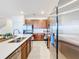 Bright kitchen with stainless steel appliances, granite countertops, and wood cabinets at 299 Marcello Blvd, Kissimmee, FL 34746