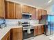 Modern kitchen featuring stainless steel appliances, quartz countertops, and rich wood cabinetry for a stylish design at 299 Marcello Blvd, Kissimmee, FL 34746
