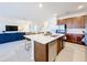 Open-concept kitchen with a large island, stainless steel appliances, and barstool seating at 299 Marcello Blvd, Kissimmee, FL 34746