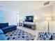Comfortable living room features a large TV, stylish lamps, and patterned accent chair at 299 Marcello Blvd, Kissimmee, FL 34746