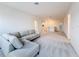 Expansive living room offers ample space with soft carpeting and a comfortable gray sectional couch at 299 Marcello Blvd, Kissimmee, FL 34746