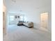Living room showcasing a cozy gray sectional, plush carpet, and natural light from windows at 299 Marcello Blvd, Kissimmee, FL 34746