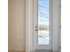 White-framed glass patio door leads to an outdoor screened-in space at 299 Marcello Blvd, Kissimmee, FL 34746