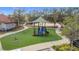 Neighborhood playground featuring various play structures and artificial turf, promoting outdoor fun and activity at 299 Marcello Blvd, Kissimmee, FL 34746