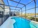 Enjoy the private screened-in pool and views of the neighborhood from your backyard at 299 Marcello Blvd, Kissimmee, FL 34746