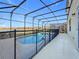 Enjoy the screened-in pool offering a serene view of the lake and surrounding community at 299 Marcello Blvd, Kissimmee, FL 34746
