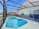 Cool off in this private screened-in pool with built-in steps for easy access and enjoyment at 299 Marcello Blvd, Kissimmee, FL 34746