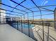 Screened-in pool offers a refreshing escape with a secure safety fence and views of the neighborhood at 299 Marcello Blvd, Kissimmee, FL 34746