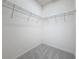 Empty walk-in closet with wire shelving and gray carpet at 299 Marcello Blvd, Kissimmee, FL 34746
