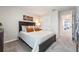 Cozy bedroom featuring a queen-sized bed, modern decor, and a convenient doorway to the rest of the home at 300 Preston Cove Dr, St Cloud, FL 34771
