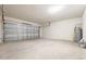Spacious two-car garage with ample room for parking and storage and with white cinder block walls at 300 Preston Cove Dr, St Cloud, FL 34771