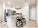 Bright kitchen featuring stainless steel appliances, granite countertops, and bar stool seating at 300 Preston Cove Dr, St Cloud, FL 34771