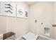 Practical laundry area featuring tile flooring, wall art, and essential hookups, blending functionality with style at 300 Preston Cove Dr, St Cloud, FL 34771