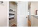 Well-organized linen closet with wire shelving and neatly folded towels for convenient storage at 300 Preston Cove Dr, St Cloud, FL 34771