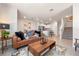 Open living room with stairs and a view into the white kitchen with stainless steel appliances at 300 Preston Cove Dr, St Cloud, FL 34771