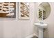 Contemporary powder room featuring a pedestal sink and decorative wall art at 300 Preston Cove Dr, St Cloud, FL 34771