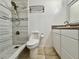Bathroom featuring a tiled shower, modern fixtures, and a white vanity with storage at 3016 Parkway Blvd # 110, Kissimmee, FL 34747
