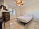 Simple bedroom with tile flooring, a modern ceiling fan, and a window overlooking the exterior at 3016 Parkway Blvd # 110, Kissimmee, FL 34747
