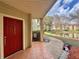 Unit entrance with a festive porch and a view of the community pond and landscaped pathway at 3016 Parkway Blvd # 110, Kissimmee, FL 34747