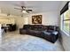 Living room with tile flooring, modern ceiling fan, and a reclining sofa with drink holders at 3016 Parkway Blvd # 110, Kissimmee, FL 34747