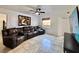 Bright living room featuring tile floors, a contemporary ceiling fan, and a large reclining sofa at 3016 Parkway Blvd # 110, Kissimmee, FL 34747