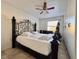 Spacious bedroom with a decorative metal bed frame, tile flooring, and a ceiling fan at 3016 Parkway Blvd # 110, Kissimmee, FL 34747