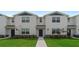 Charming two-story townhome with a well-maintained lawn and neutral-toned facade at 308 Preston Cove Dr, St Cloud, FL 34771