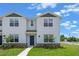 New construction townhome with a stone accent base and small front yard at 312 Preston Cove Dr, St Cloud, FL 34771