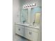 Bright bathroom features double vanity with quartz countertop and modern lighting at 327 15Th N St, Haines City, FL 33844