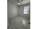 Bedroom featuring fan, window, and marble tile flooring at 330 W Necho Ave, Lake Alfred, FL 33850