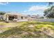 Large backyard featuring a patio, dining set, fire pit, and green grass at 34429 Alameda Dr, Sorrento, FL 32776