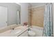 Clean bathroom featuring a tub/shower combo with tiled walls and a single sink vanity at 34429 Alameda Dr, Sorrento, FL 32776