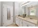 Bright bathroom featuring double sinks, granite countertops, and modern lighting fixtures at 34429 Alameda Dr, Sorrento, FL 32776