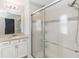 Bright bathroom featuring a shower with glass doors and a neutral vanity at 34429 Alameda Dr, Sorrento, FL 32776