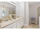 Bright bathroom featuring double sinks, granite countertops, and modern lighting fixtures at 34429 Alameda Dr, Sorrento, FL 32776