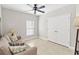 Bedroom with a neutral colored sofa, fan, and closet with double doors at 34429 Alameda Dr, Sorrento, FL 32776