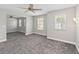 Open bedroom with gray carpet and natural light from the window at 34429 Alameda Dr, Sorrento, FL 32776