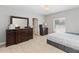 Spacious bedroom with tile flooring, dresser, and a large window at 34429 Alameda Dr, Sorrento, FL 32776