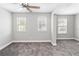 Large bedroom with carpet, neutral walls, and three windows for lots of light at 34429 Alameda Dr, Sorrento, FL 32776