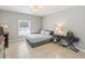 Comfortable bedroom with tile flooring, chandelier, and a stylish platform bed at 34429 Alameda Dr, Sorrento, FL 32776