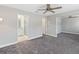Carpeted bedroom showcasing an ensuite bathroom and multiple doors at 34429 Alameda Dr, Sorrento, FL 32776