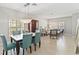 Elegant dining area with modern chandelier and dining table set for six at 34429 Alameda Dr, Sorrento, FL 32776