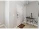 Welcoming entryway with a white front door and decorative accents on table at 34429 Alameda Dr, Sorrento, FL 32776