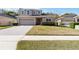 Charming two-story home with well-manicured lawn and a brick driveway at 34429 Alameda Dr, Sorrento, FL 32776