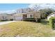 Charming two-story home with well-manicured lawn and a brick driveway at 34429 Alameda Dr, Sorrento, FL 32776