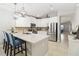 Stylish kitchen features stainless steel appliances, white cabinetry, granite countertops, and a center island with seating at 34429 Alameda Dr, Sorrento, FL 32776