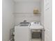 Functional laundry room featuring a modern washer and dryer set at 34429 Alameda Dr, Sorrento, FL 32776