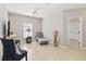 Cozy living room with tile flooring, neutral walls, and stylish accent furniture at 34429 Alameda Dr, Sorrento, FL 32776