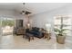 Inviting living room with tile floors, a ceiling fan, sliding glass doors to the patio, and neutral decor at 34429 Alameda Dr, Sorrento, FL 32776